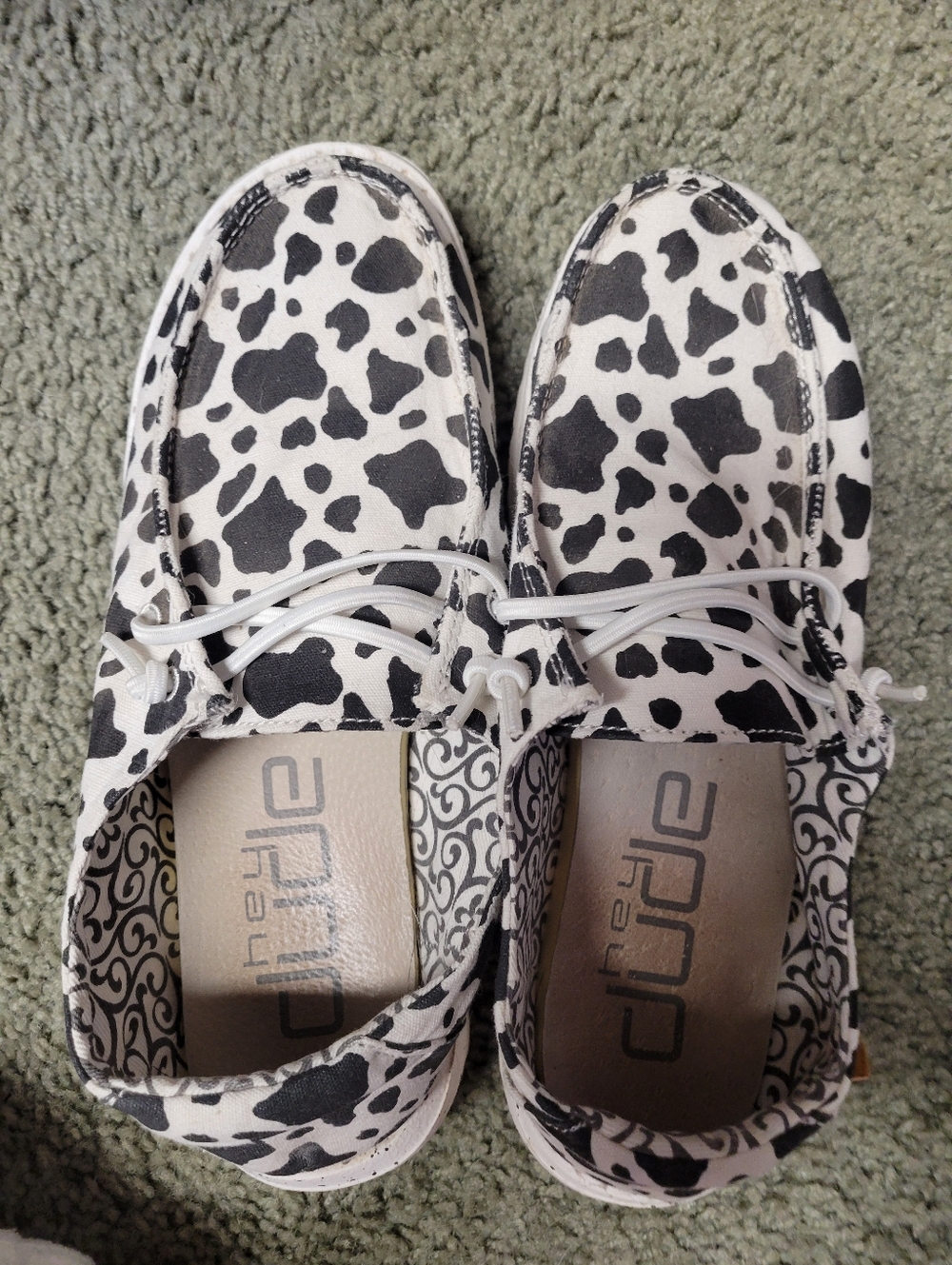 Hey Dude Women's Cow Spot Slip-Ons in Black and White